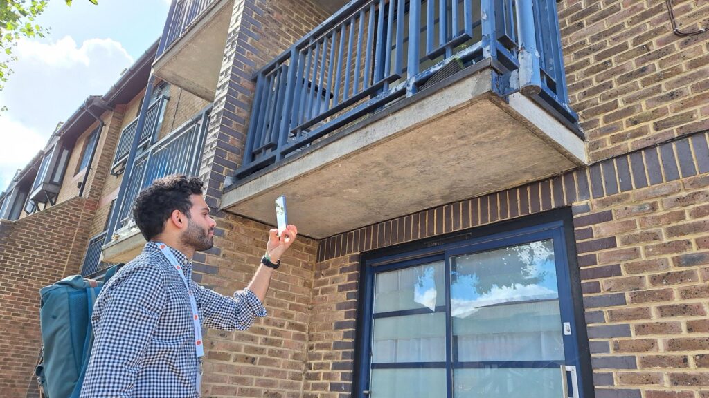 man with mobile phone looking at flats